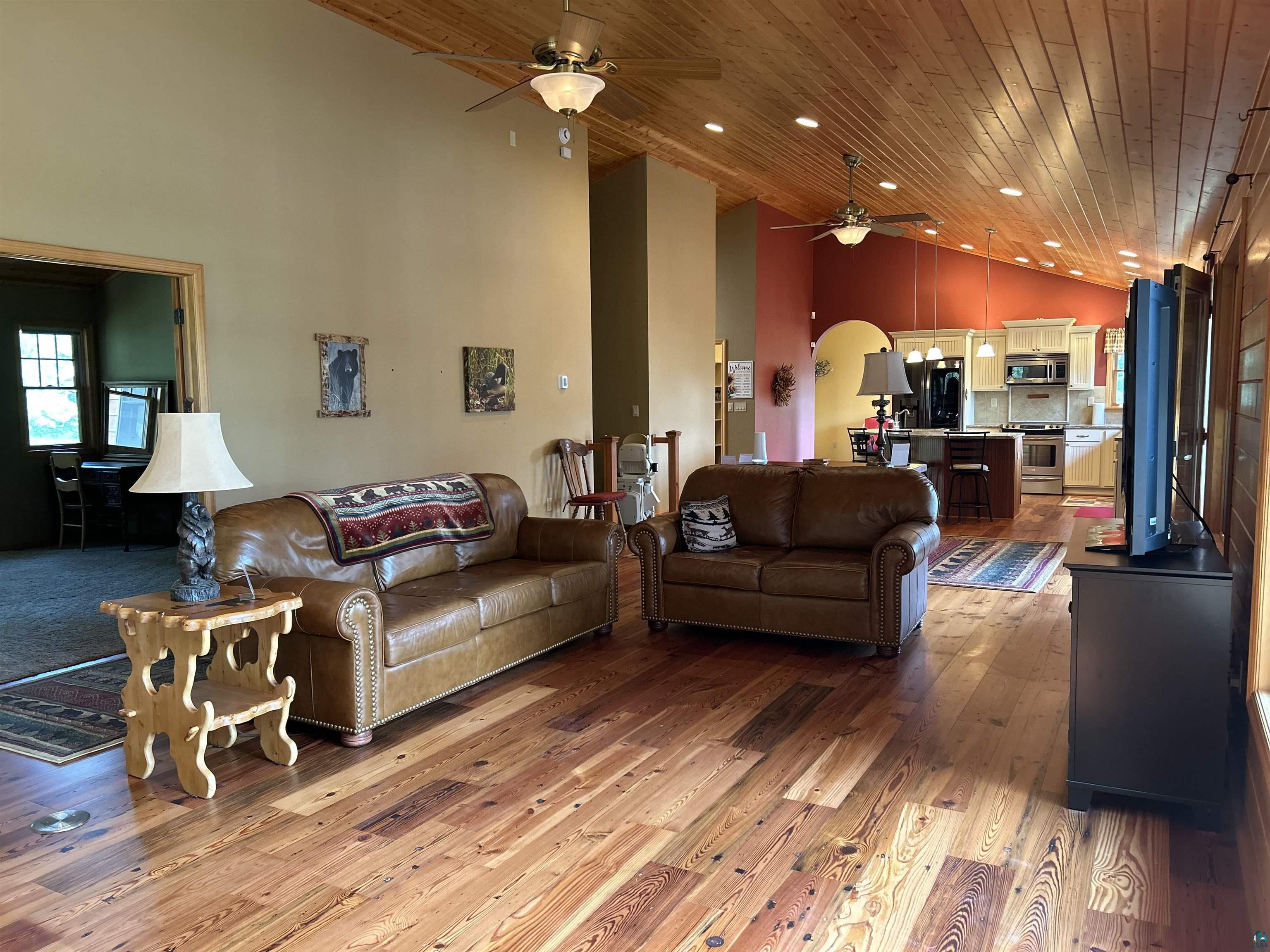 10115 Island Lake Road Solon Springs, WI 54873 - Photo 51 of 56 Living room featuring a ceiling fan, high vaulted ceiling, wood finished floors, arched walkways, and recessed lighting
