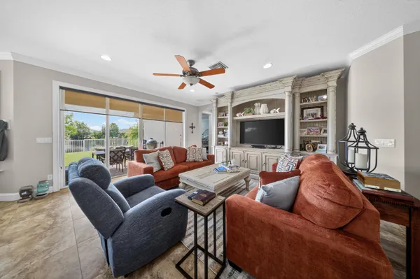 a room with stainless steel appliances kitchen island granite countertop a table chairs sink and cabinets