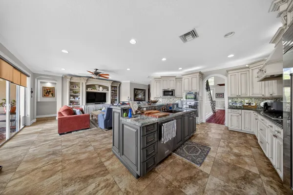 a kitchen with a stove a sink a microwave and cabinets