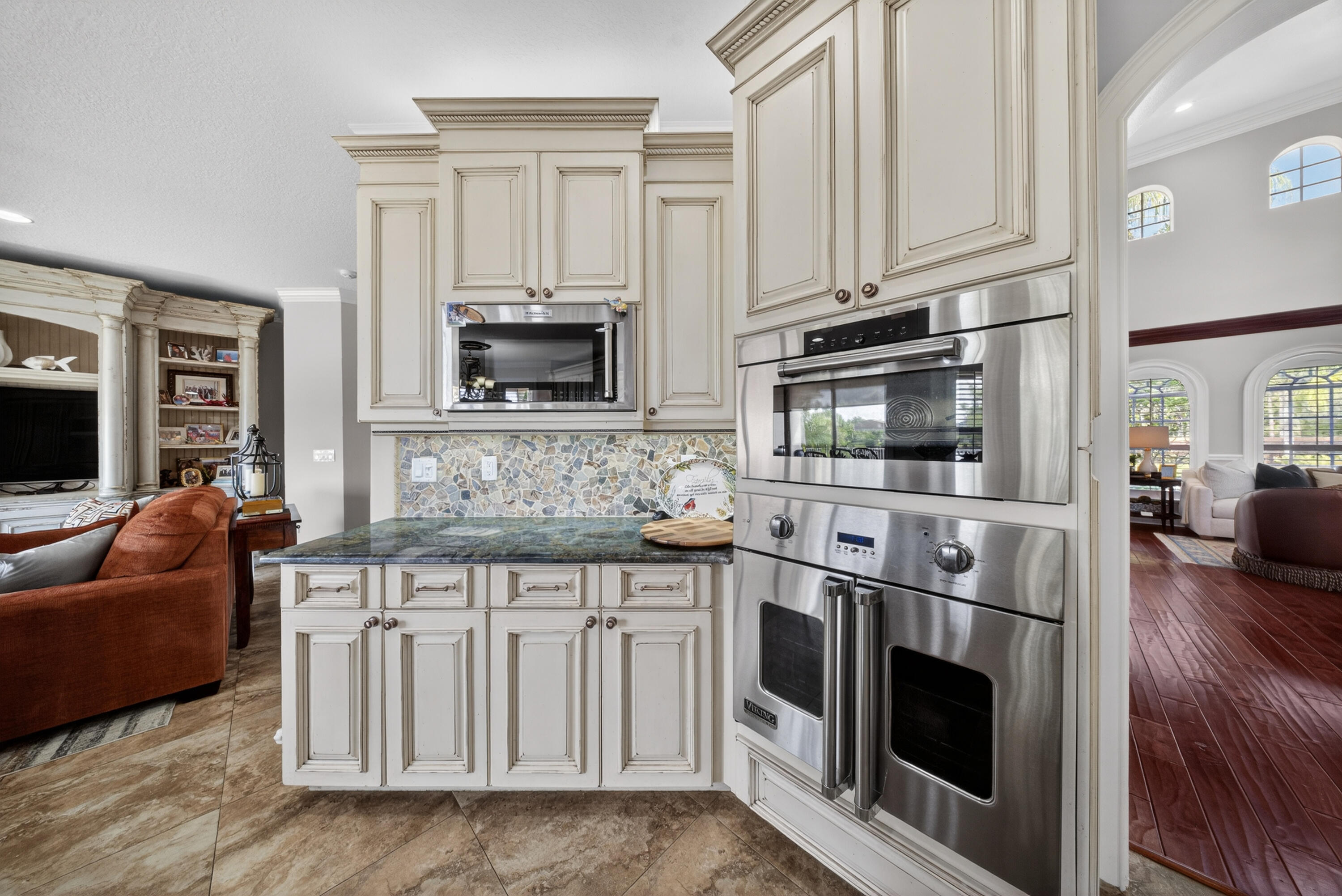 1315 Southeast Conference Circle Stuart, FL 34997 - Photo 18 of 55 a kitchen with stainless steel appliances granite countertop a stove a sink and a microwave