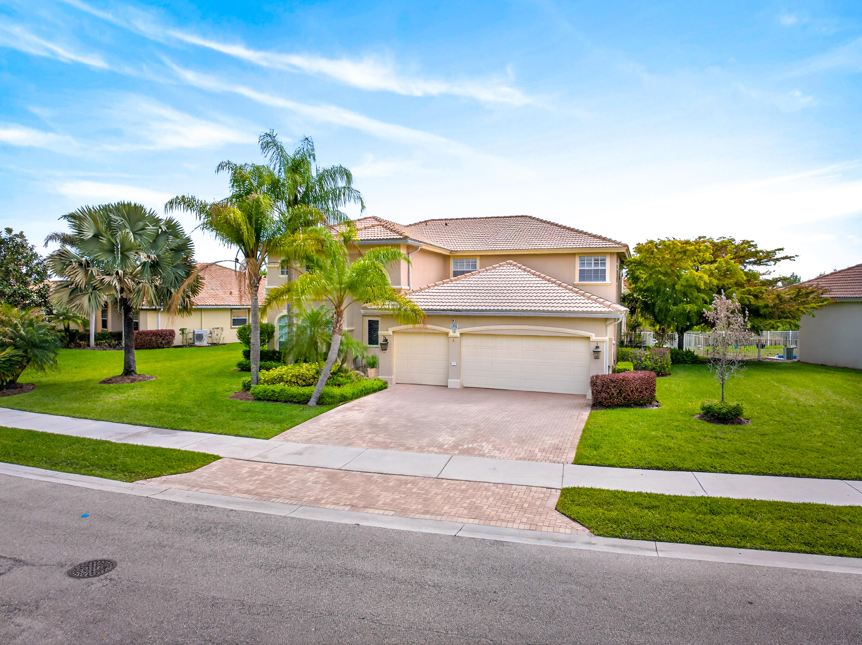 1315 Southeast Conference Circle Stuart, FL 34997 - Photo 2 of 55 a front view of a house with a yard and garage