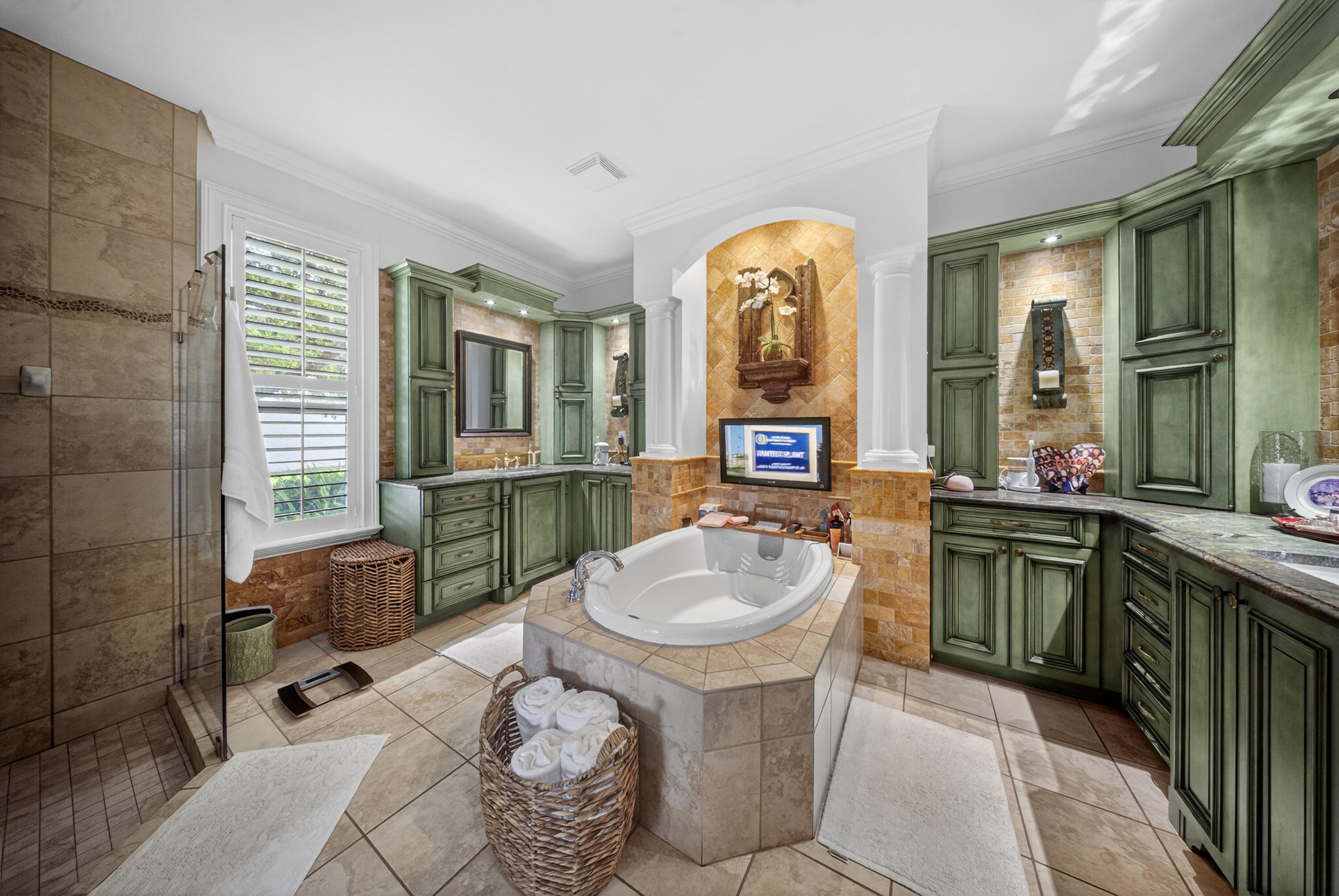 1315 Southeast Conference Circle Stuart, FL 34997 - Photo 34 of 55 a spacious bathroom with a granite countertop sink a mirror and a bathtub