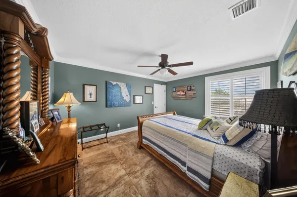 a bathroom with a granite countertop toilet sink and mirror