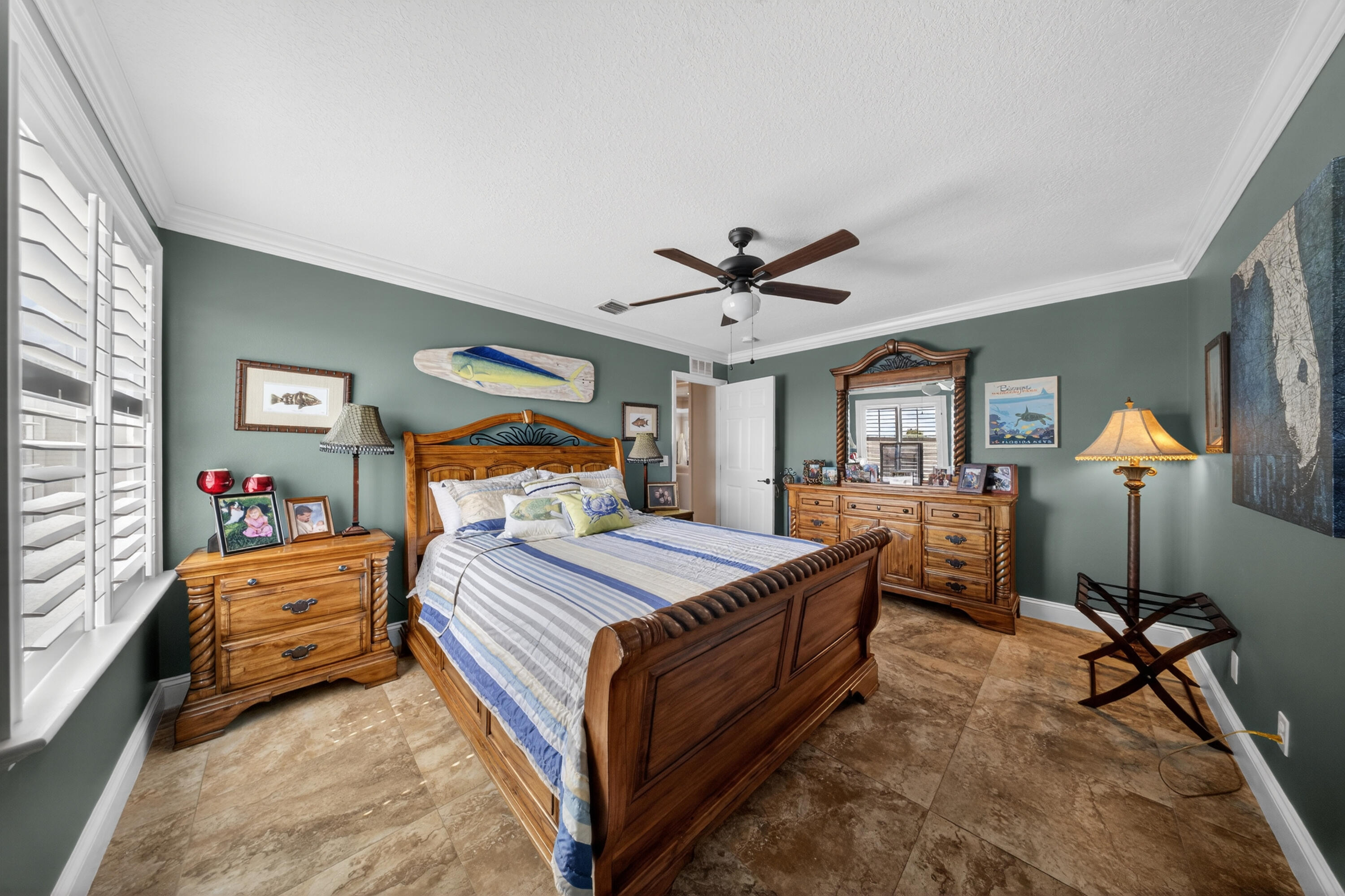 1315 Southeast Conference Circle Stuart, FL 34997 - Photo 41 of 55 a bedroom with a bed and a chandelier