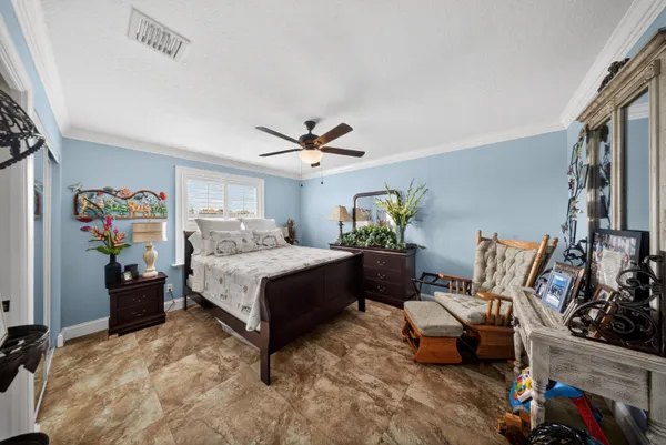a bedroom with a large bed and a chandelier