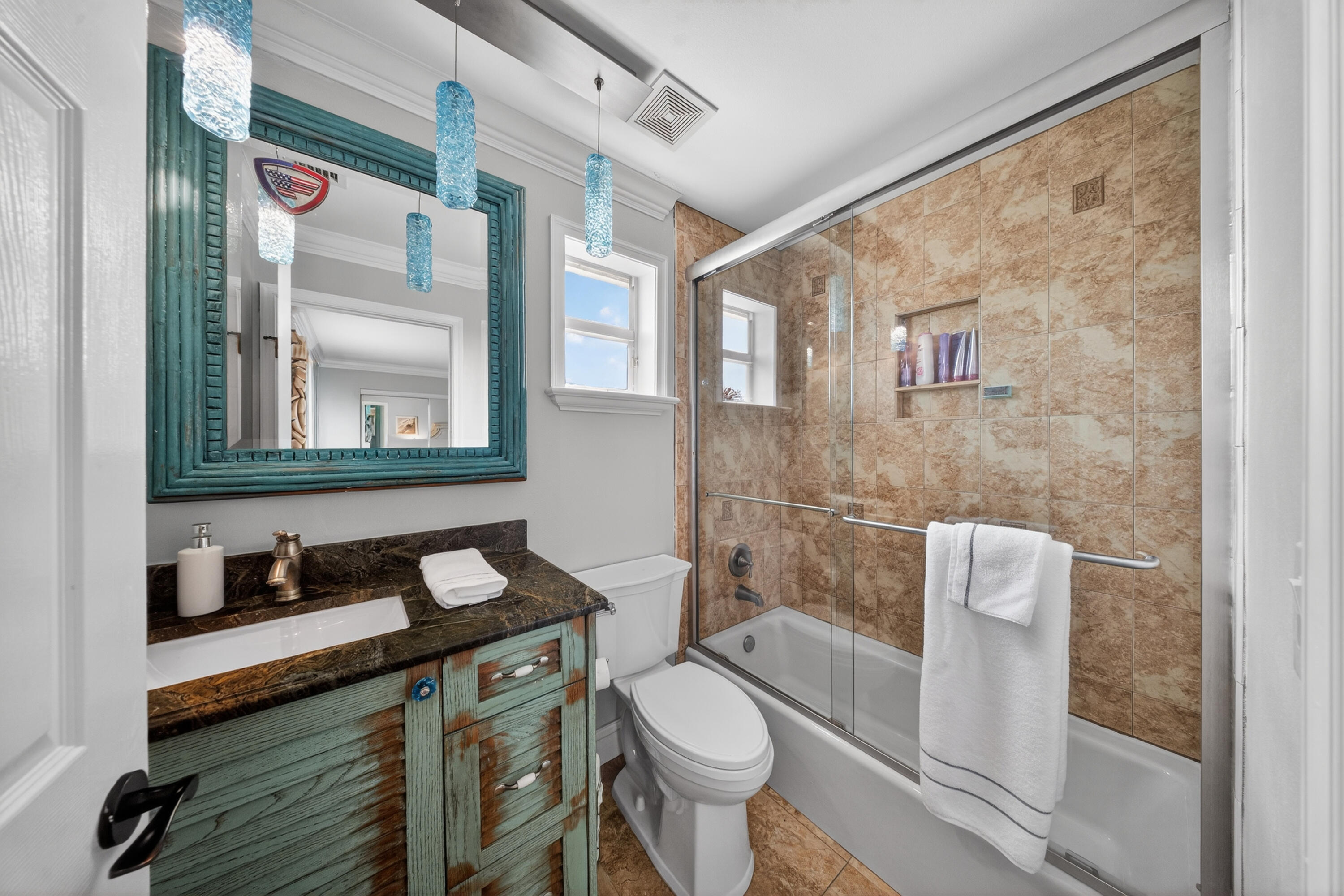 1315 Southeast Conference Circle Stuart, FL 34997 - Photo 44 of 55 a bathroom with a granite countertop toilet sink and mirror