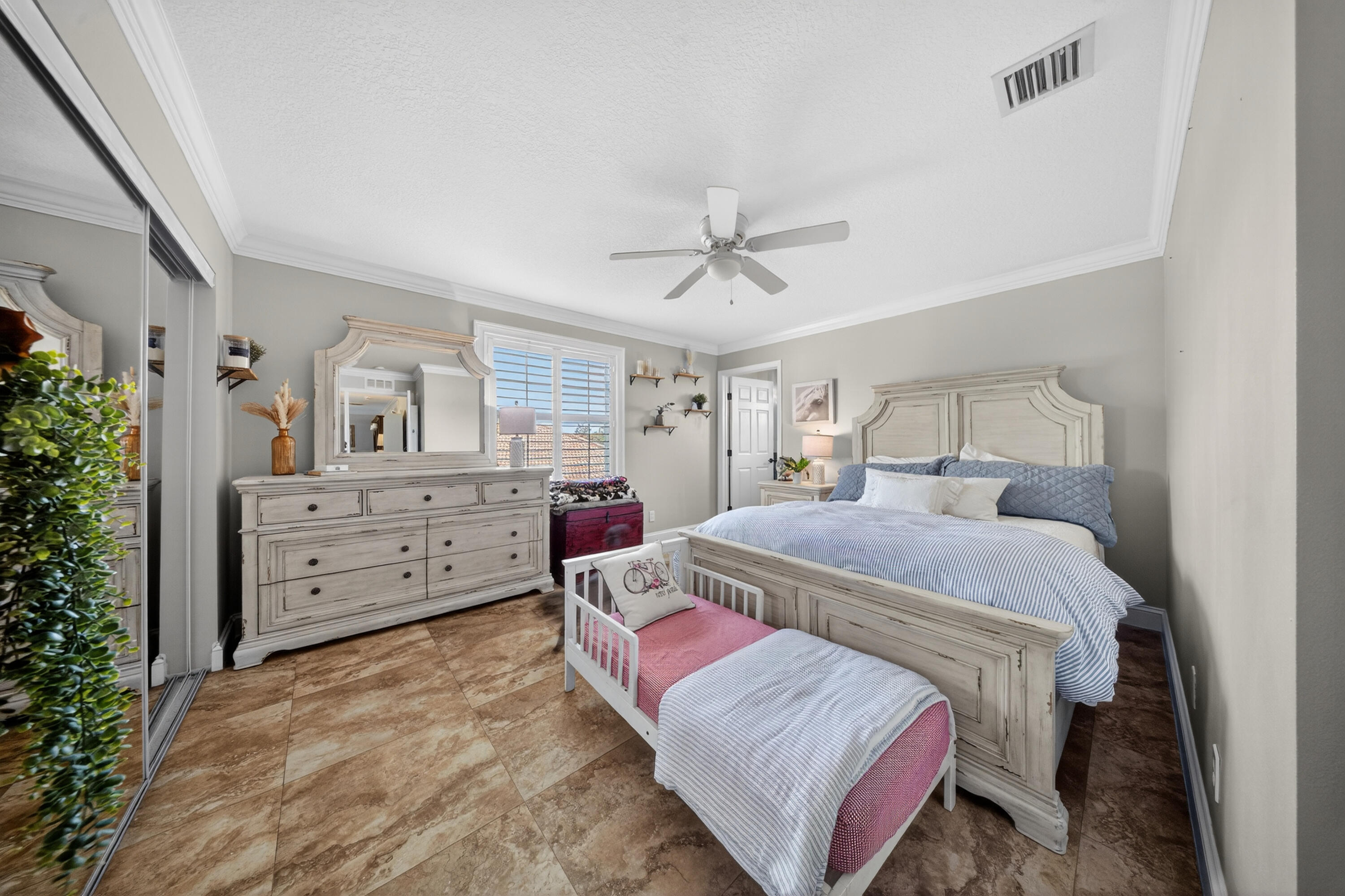 1315 Southeast Conference Circle Stuart, FL 34997 - Photo 46 of 55 a bedroom with a large bed and a chandelier