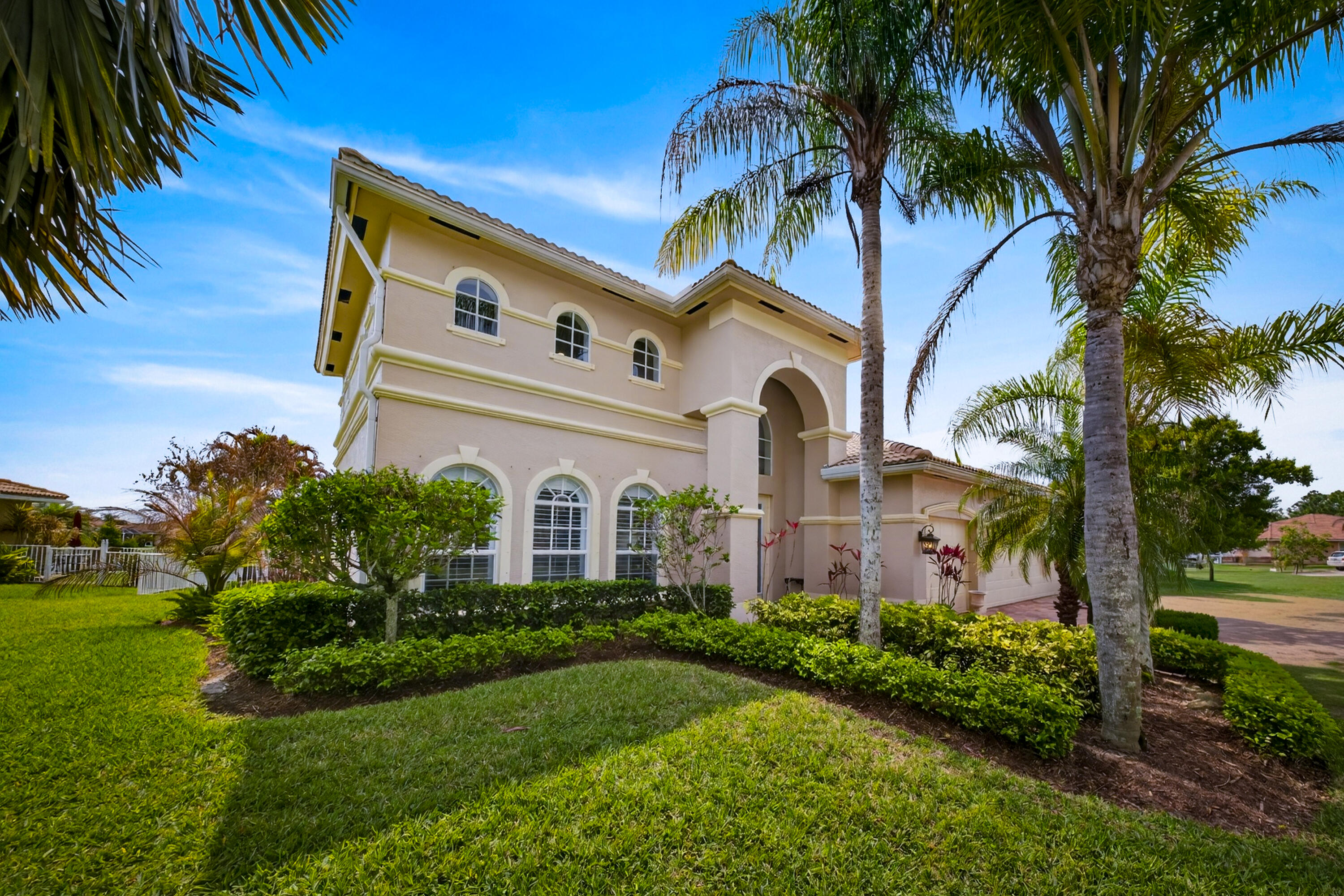 1315 Southeast Conference Circle Stuart, FL 34997 - Photo 52 of 55 a front view of a house with a garden