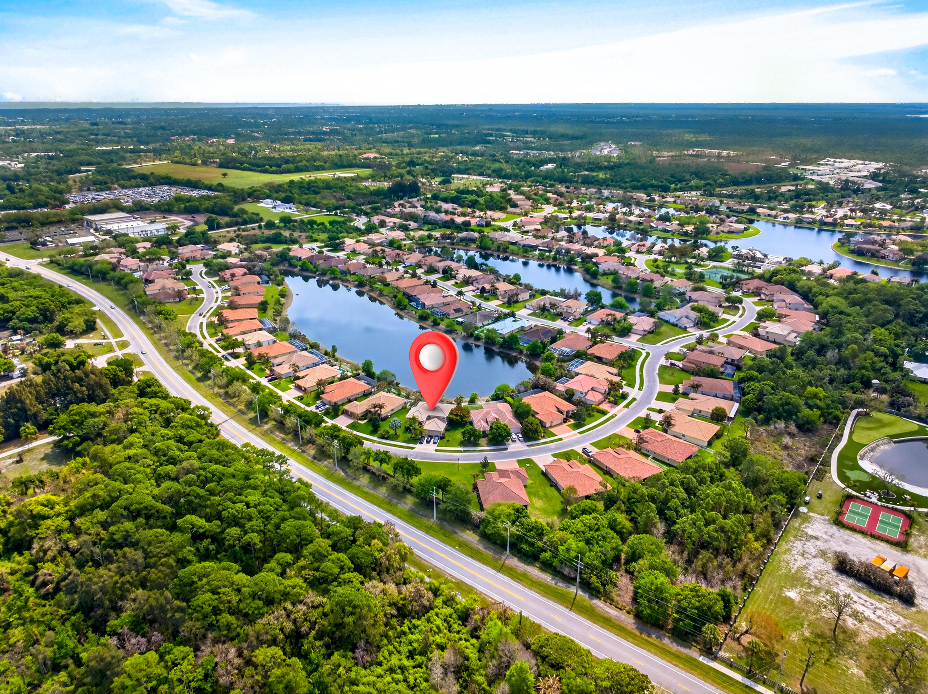 1315 Southeast Conference Circle Stuart, FL 34997 - Photo 53 of 55 an aerial view of residential houses with outdoor space and trees