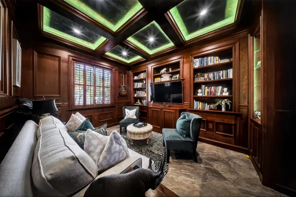 a living room with furniture and a view of kitchen