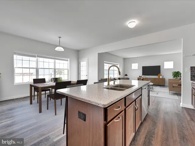 a kitchen with a kitchen island a sink table and chairs