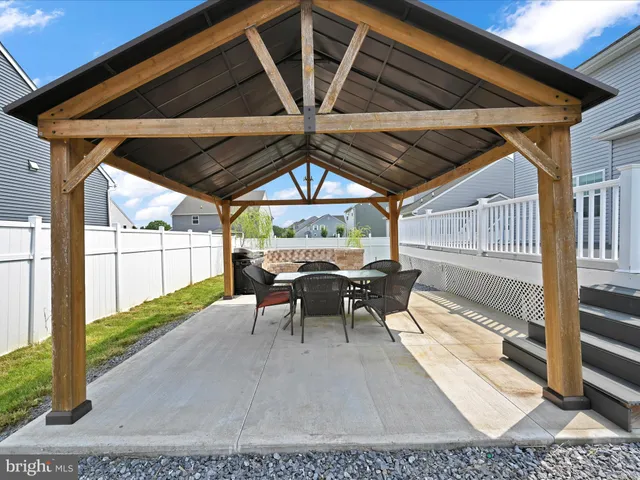 a view of a patio with table and chairs
