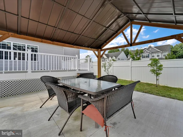 a view of backyard with table and chairs