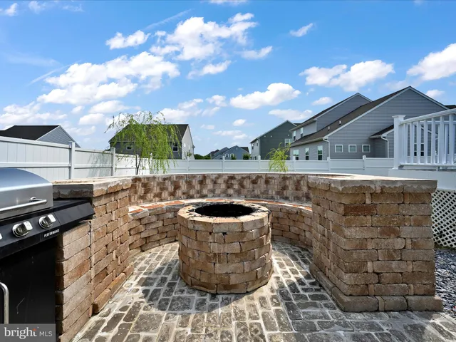 a view of a patio with wooden fence