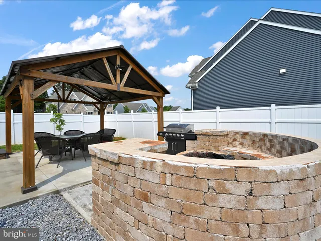 a roof deck with table and chairs a barbeque