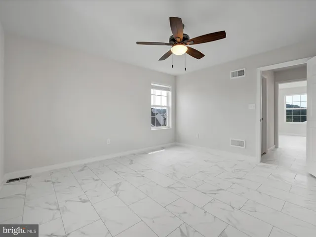 a view of a livingroom with a ceiling fan and window