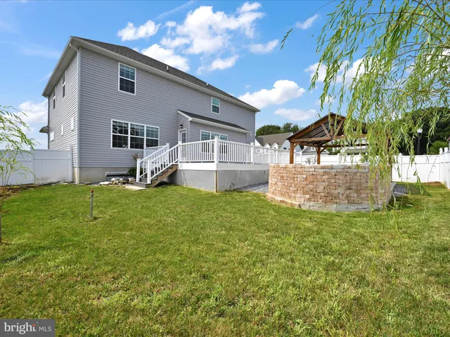 a view of a house with a yard and sitting area