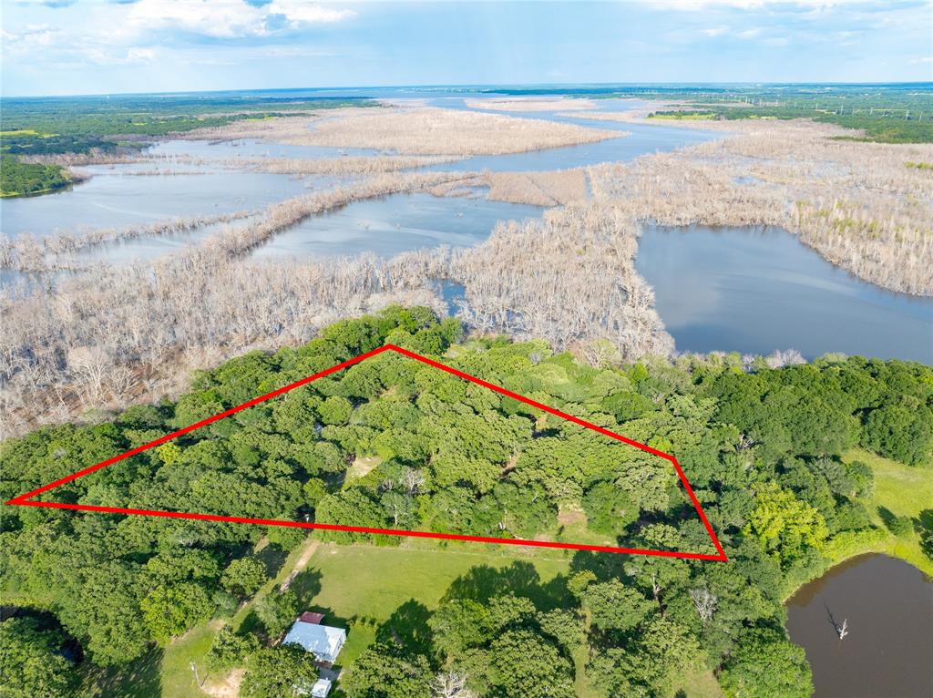 4776 County Road 2610 Bonham, TX 75418 - Photo 21 of 38 a view of a lake with a beach