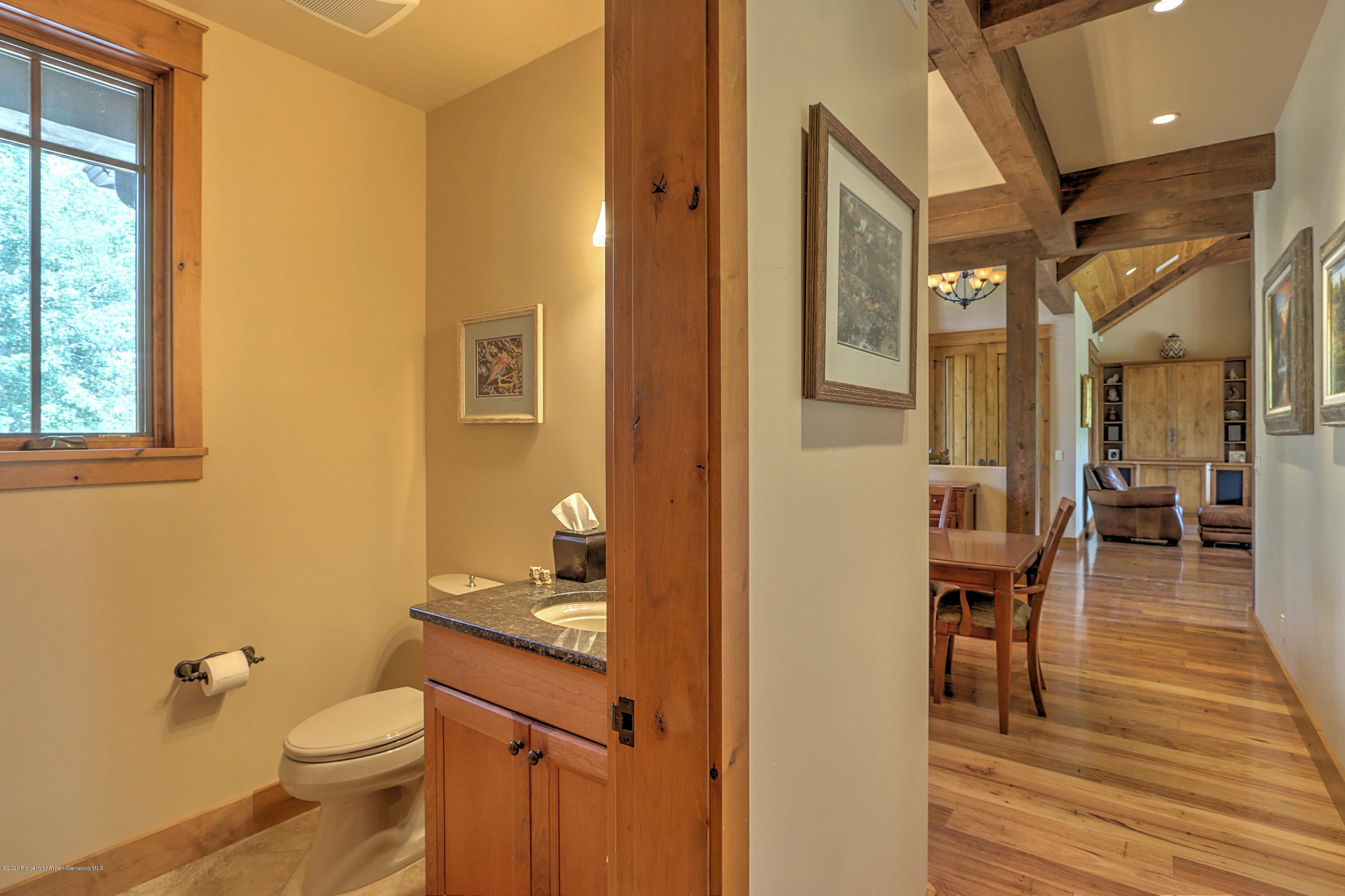 54 Diamond A Ranch Road Carbondale, CO 81623 - Photo 23 of 43 a bathroom with a granite countertop toilet a sink and a mirror