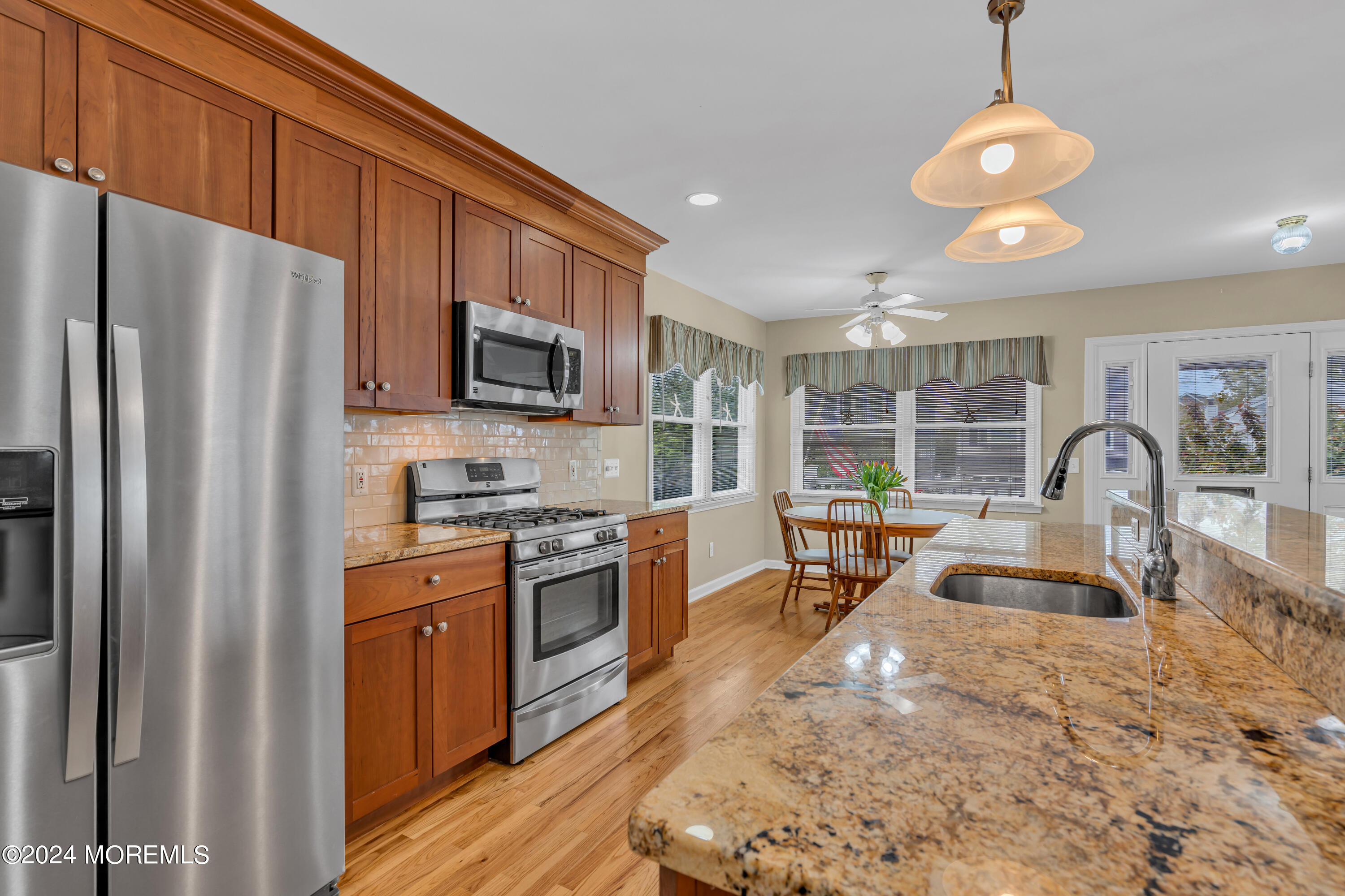 564 Perch Avenue Manasquan, NJ 08736 - Photo 11 of 49 a kitchen with stainless steel appliances granite countertop a sink refrigerator stove and microwave