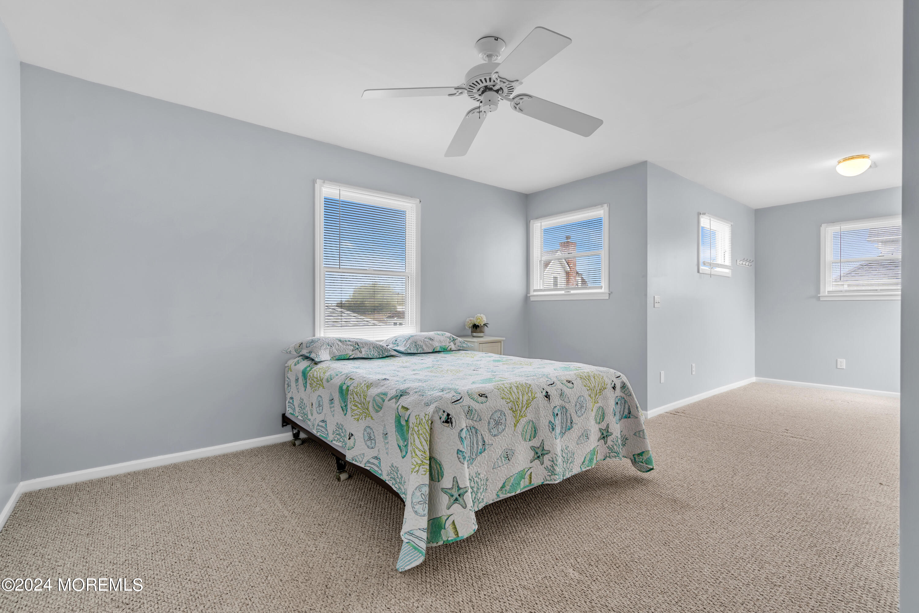 564 Perch Avenue Manasquan, NJ 08736 - Photo 17 of 49 a spacious bedroom with a bed and a chandelier