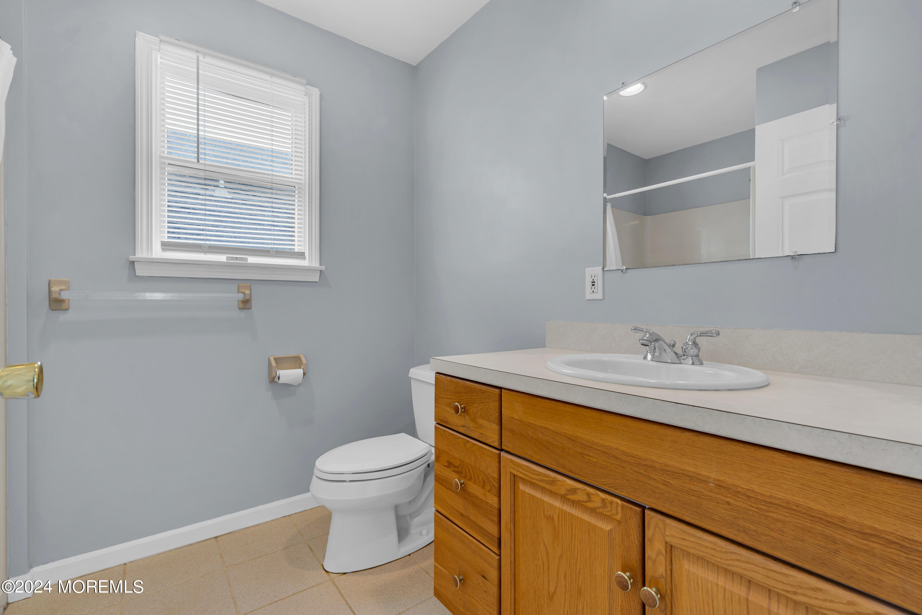 564 Perch Avenue Manasquan, NJ 08736 - Photo 24 of 49 a bathroom with a granite countertop sink a toilet and a mirror