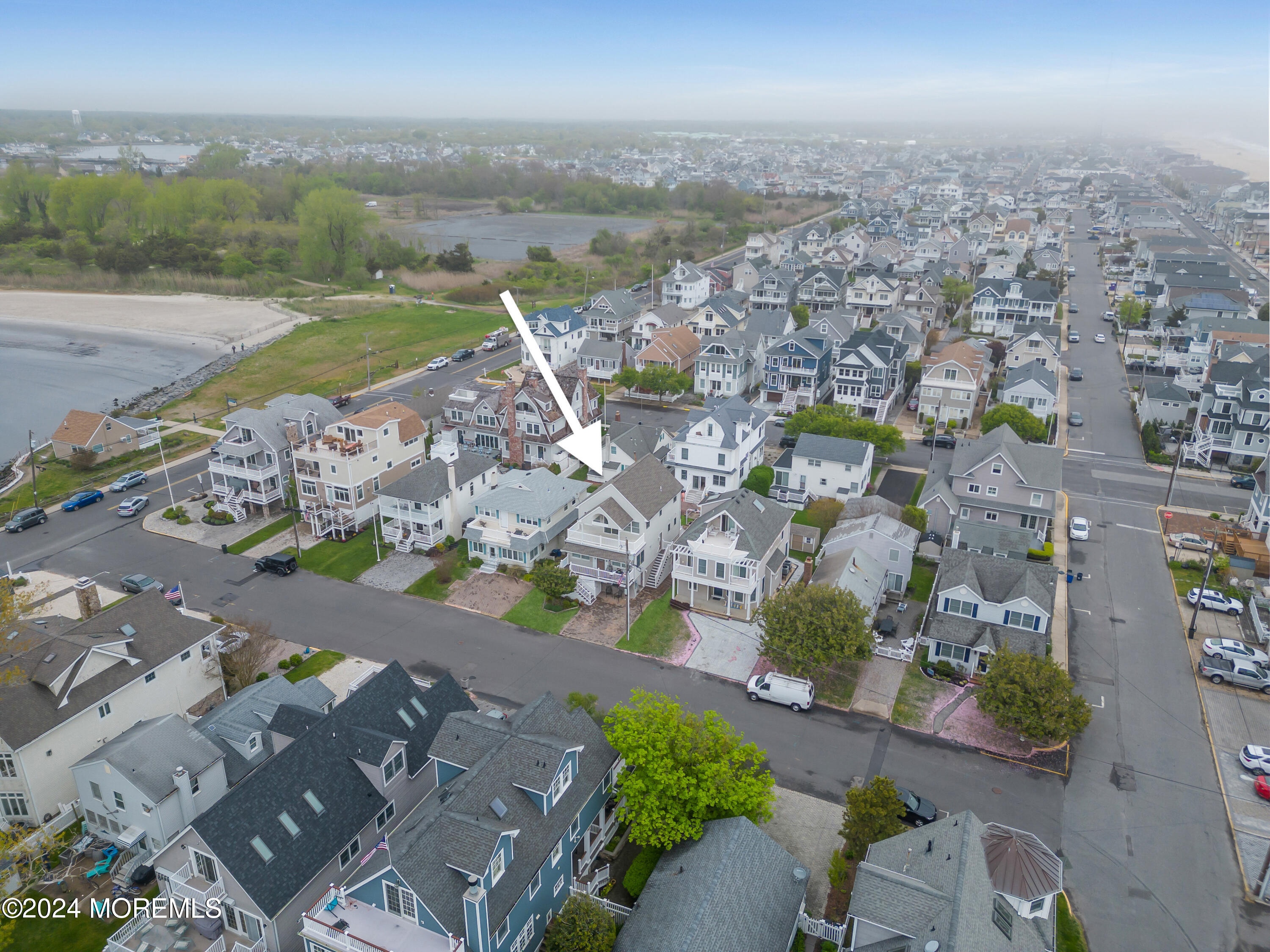 564 Perch Avenue Manasquan, NJ 08736 - Photo 37 of 49 an aerial view of a city with lots of residential buildings and ocean view in back