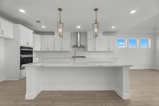 a kitchen with kitchen island a sink stainless steel appliances and cabinets