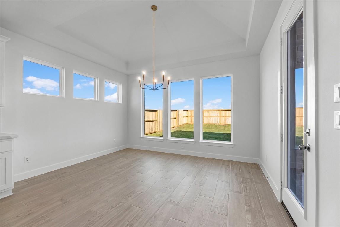 113 Meadow Beauty Lane Georgetown, TX 78633 - Photo 7 of 23 a view of an empty room with wooden floor and a window