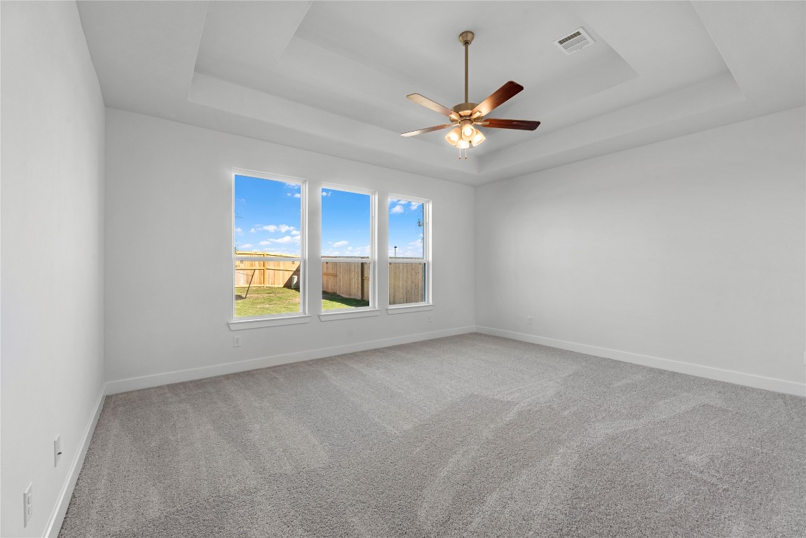 113 Meadow Beauty Lane Georgetown, TX 78633 - Photo 8 of 23 an empty room with a window and a ceiling fan