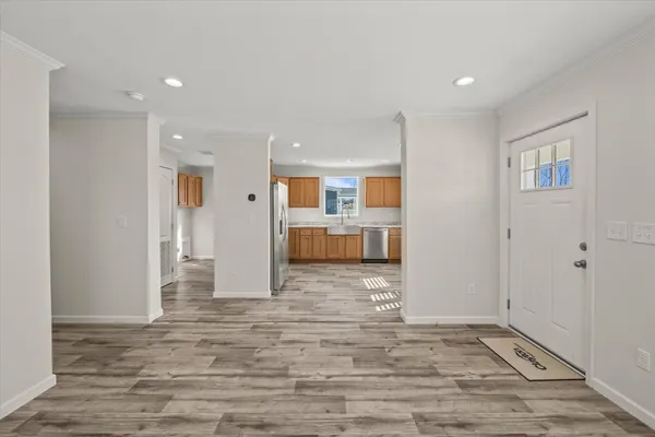a view of a kitchen with furniture and wooden floor