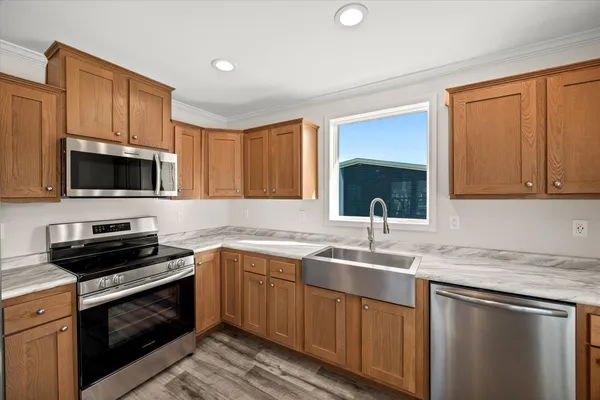 a kitchen with a sink stove and microwave