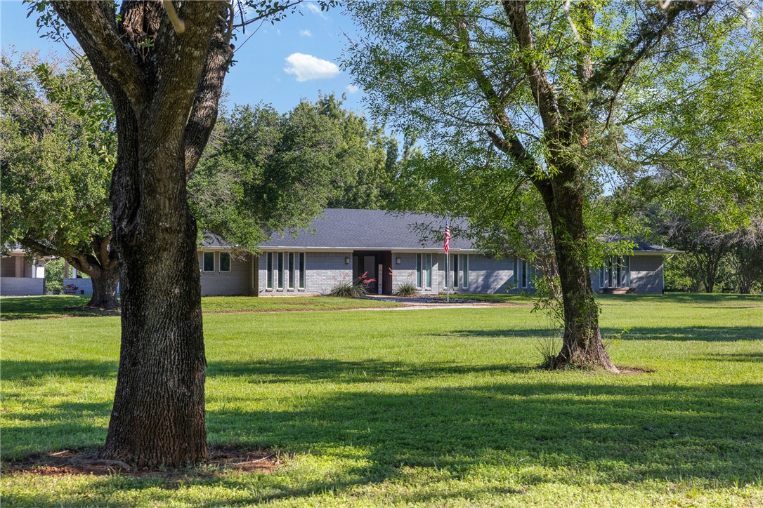 871 Cazey Loop Franklin, TX 77856 - Photo 3 of 42 a view of a big house in a big yard with a big yard and large trees