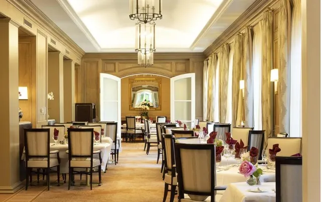 a dining room with furniture window and wooden floor