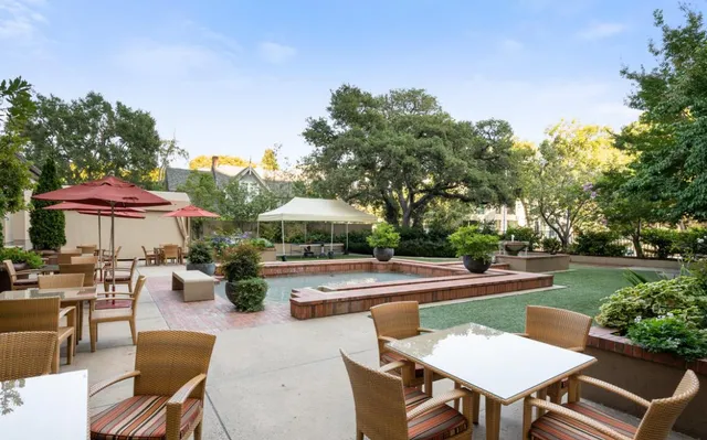 a view of a patio with chairs and tables