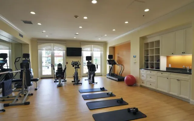 a room with gym equipment and a flat screen tv