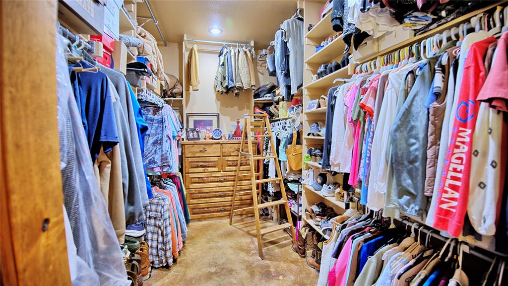 4509 Lazy E Road St. Jo, TX 76265 - Photo 33 of 39 a view of walk in closet with clothes