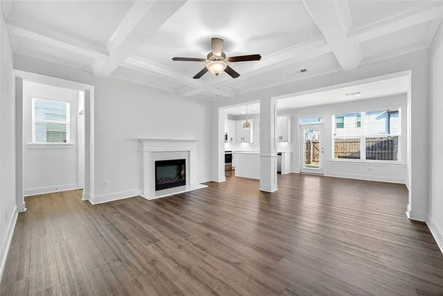 wooden floor fireplace and windows in an empty room