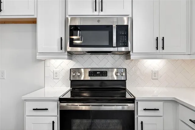 a stove top oven sitting inside of a kitchen