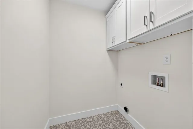 a view of storage and utility room with window