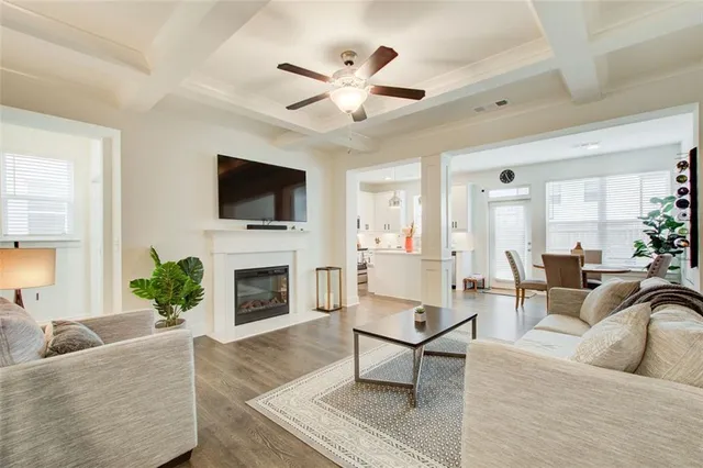a living room with furniture a fireplace and a flat screen tv