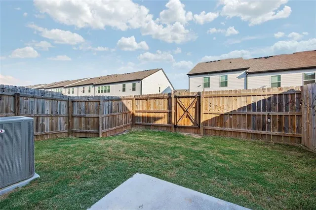 a view of a house with a yard and deck