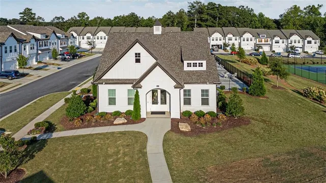 an aerial view of a tennis ground and a ocean view