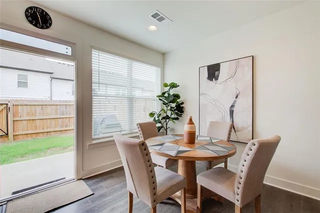 a view of a dining room with furniture window and wooden floor