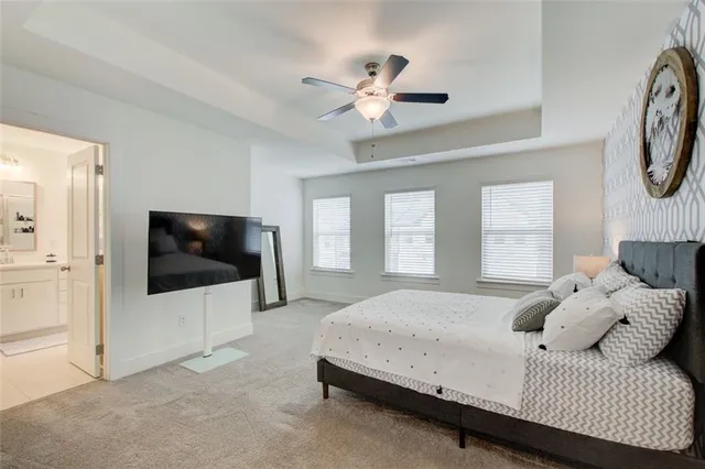 a living room with a bed furniture and a flat screen tv