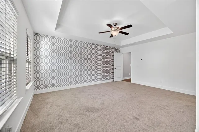 a view of a livingroom with a ceiling fan and window