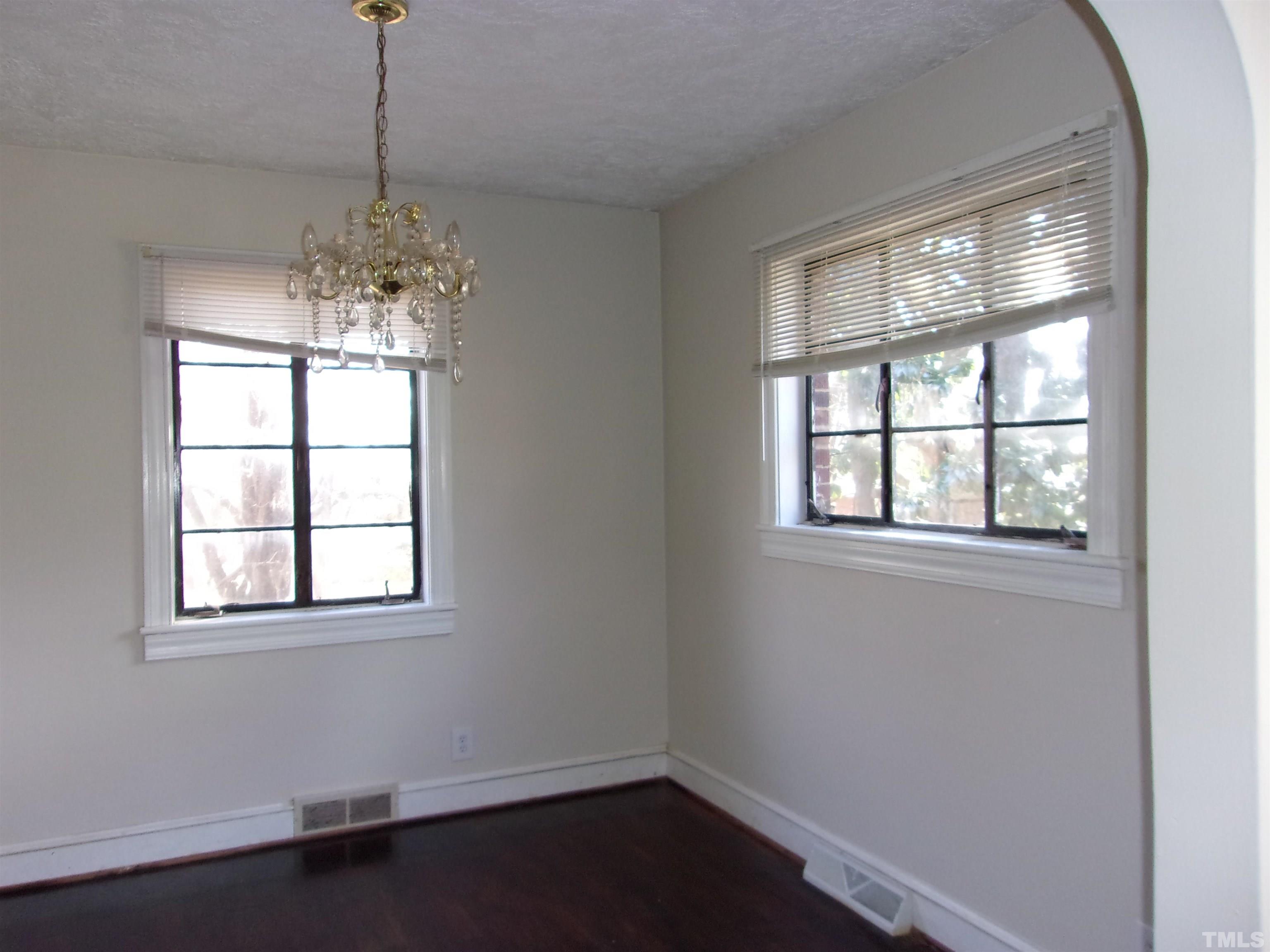 132 Trotter Street Roxboro, NC 27573 - Photo 5 of 12 a view of a room with windows and chandelier