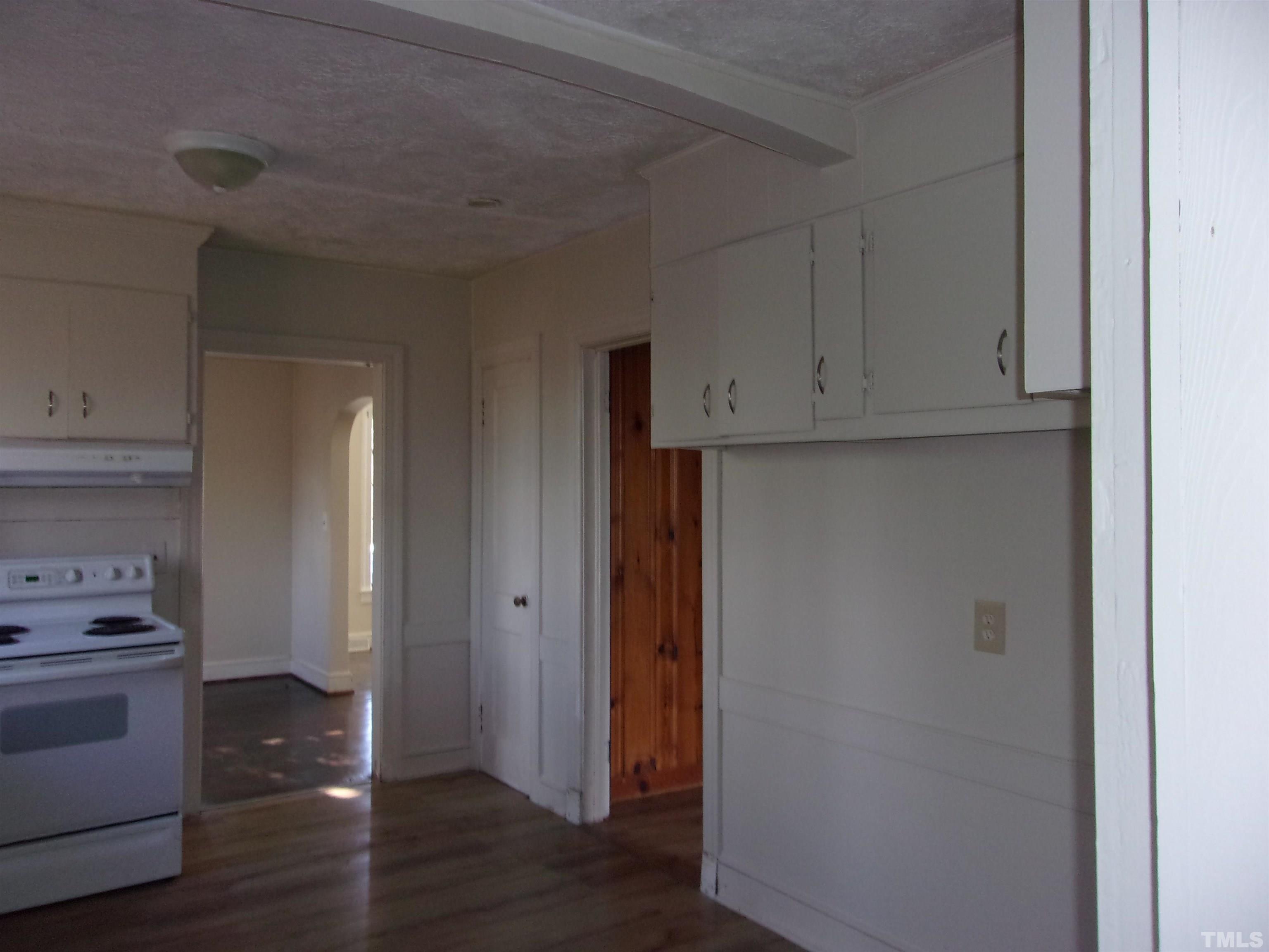 132 Trotter Street Roxboro, NC 27573 - Photo 7 of 12 a view of cabinets and wooden floor