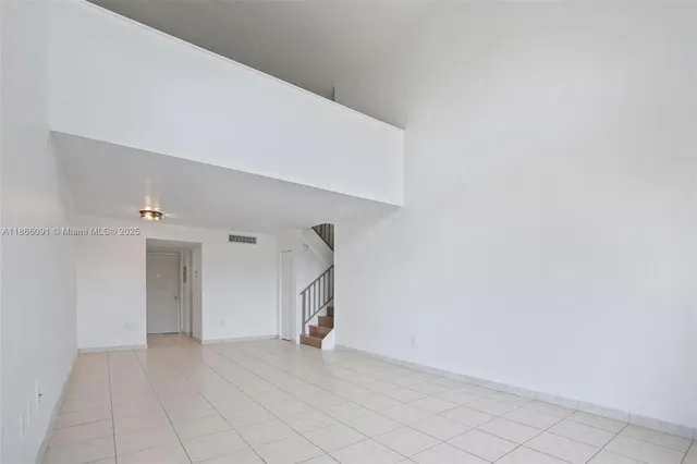 a kitchen with stainless steel appliances granite countertop a sink and white cabinets