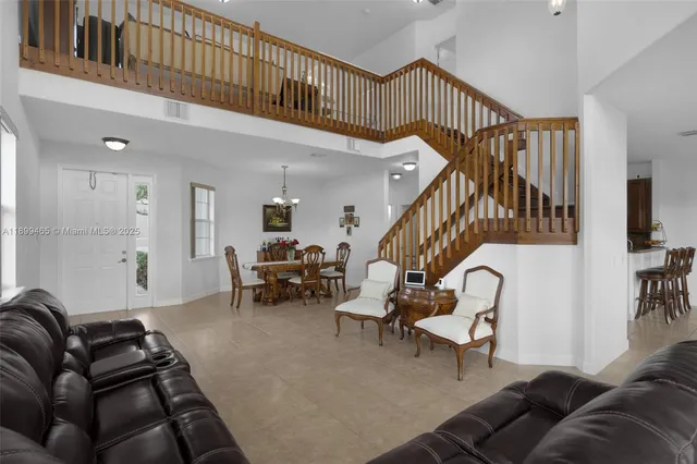a view of a dining room with furniture wooden floor and chandelier